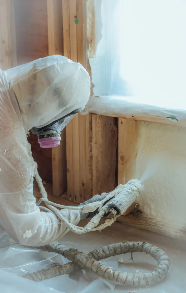 Spray foam being applied to a residential cavity